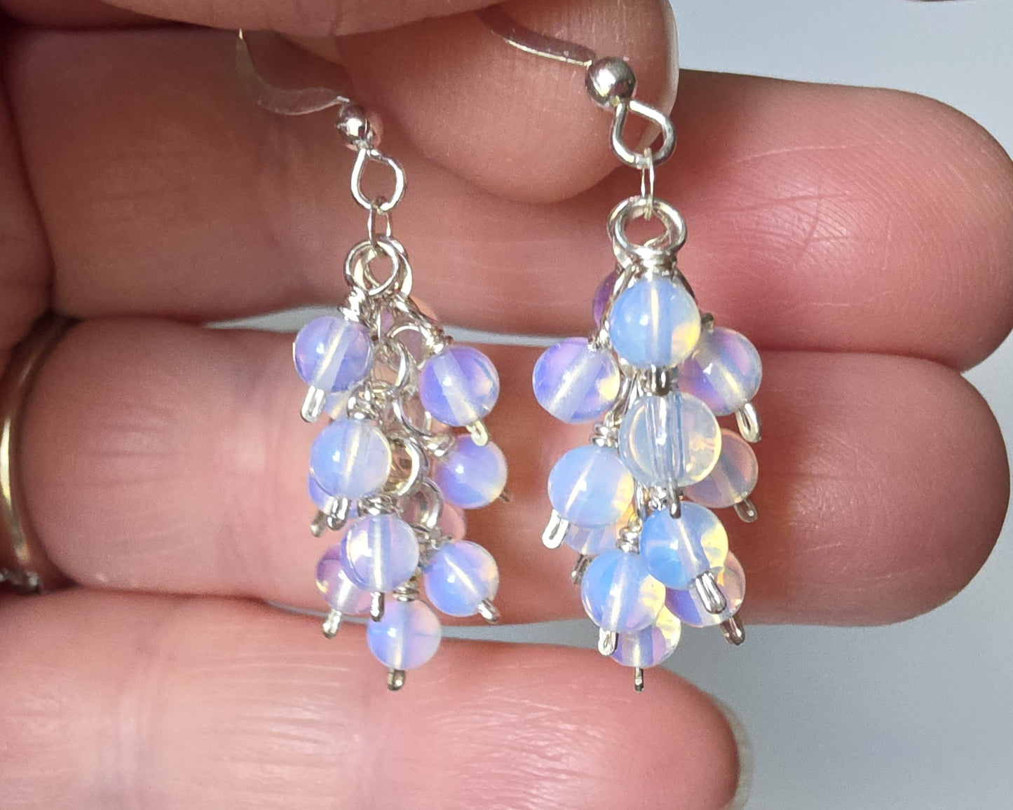 Sterling Silver Opalite Cluster earrings with blue gold stones on french earring hooks on hand 