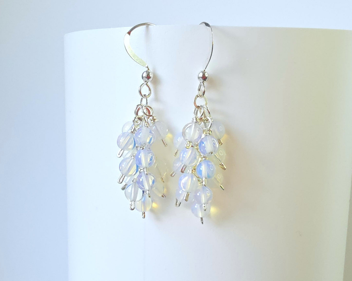 Sterling Silver Opalite Cluster earrings with blue gold stones on French earring hooks on white background 