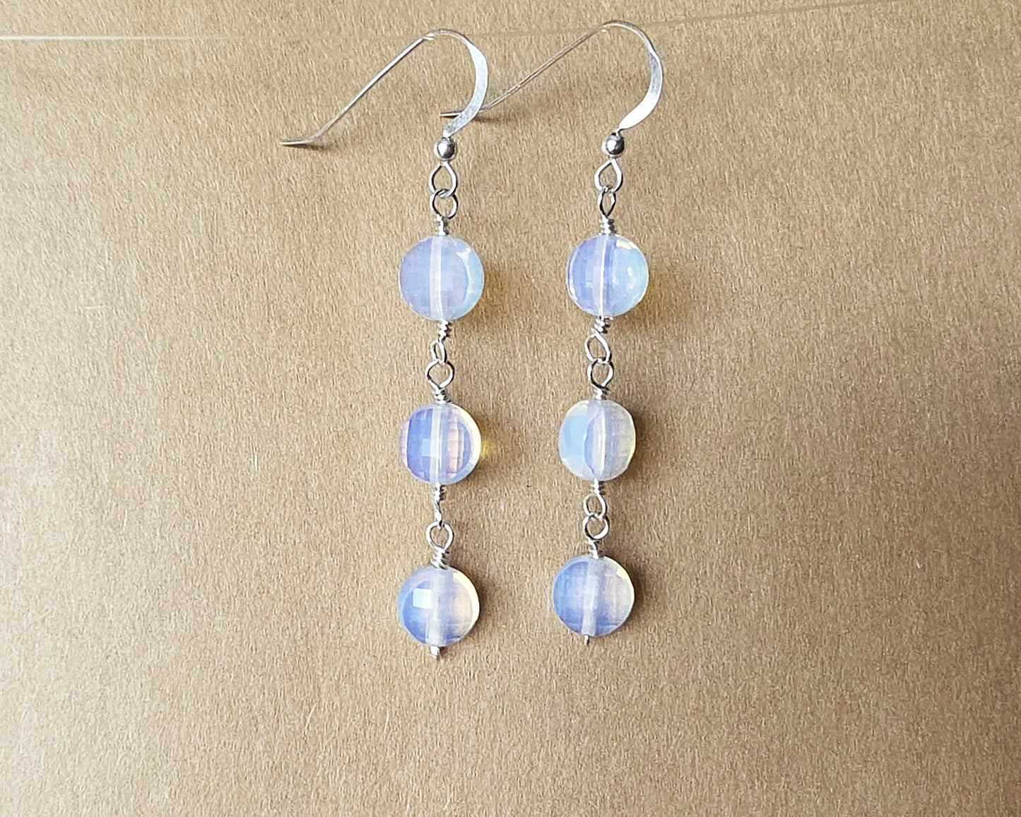 Long Three Stone Opalite Earrings with Sterling Silver Earring hooks on beige background 