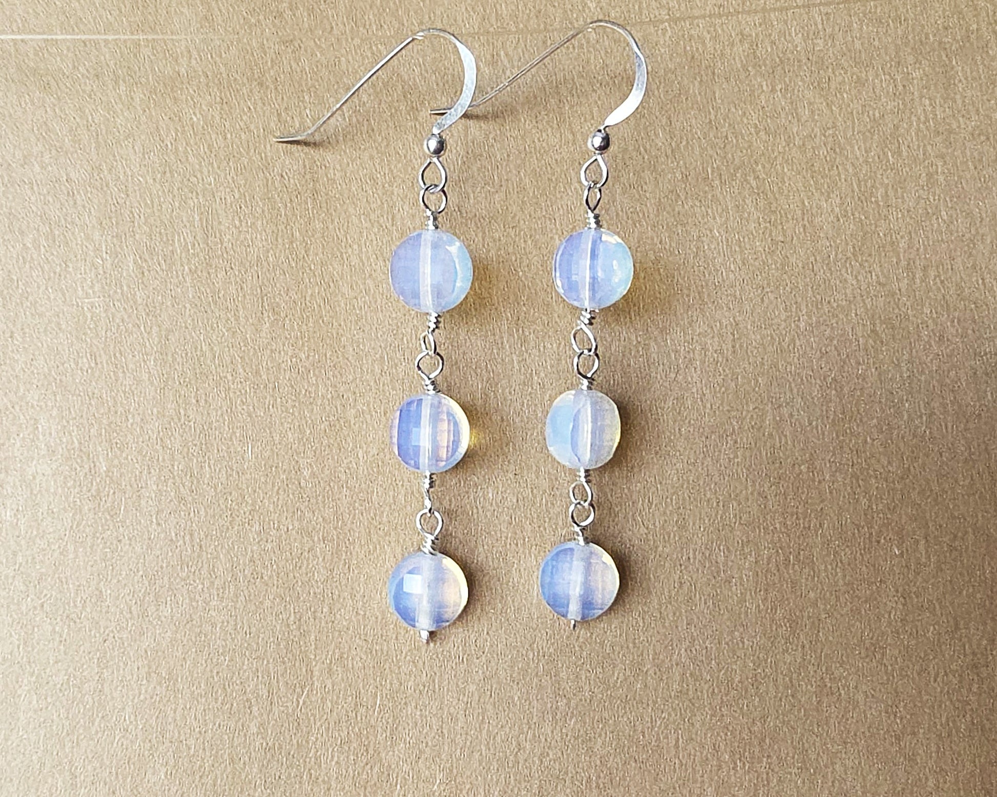 Long Three Stone Opalite Earrings with Sterling Silver Earring hooks on beige background 