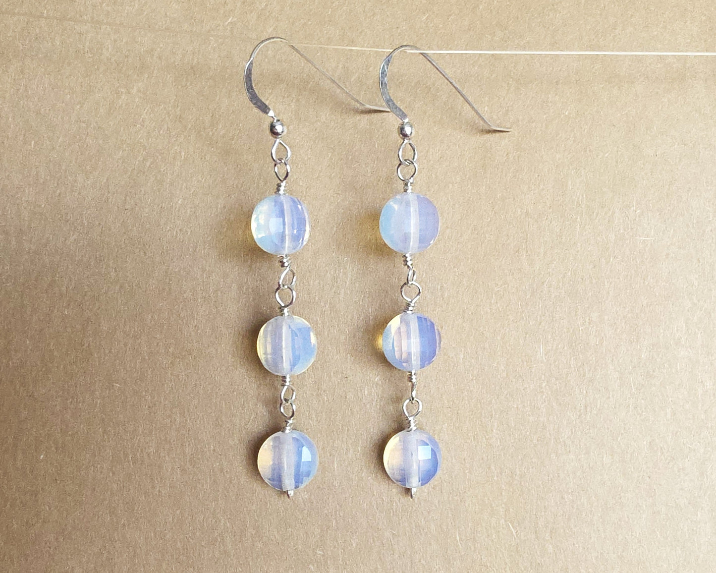 Long Three Stone Opalite Earrings with Sterling Silver Earring hooks on beige background 