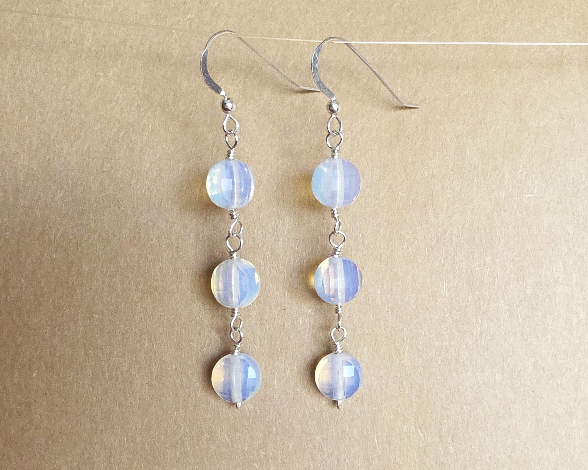 Long Three Stone Opalite Earrings with Sterling Silver Earring hooks on beige background 