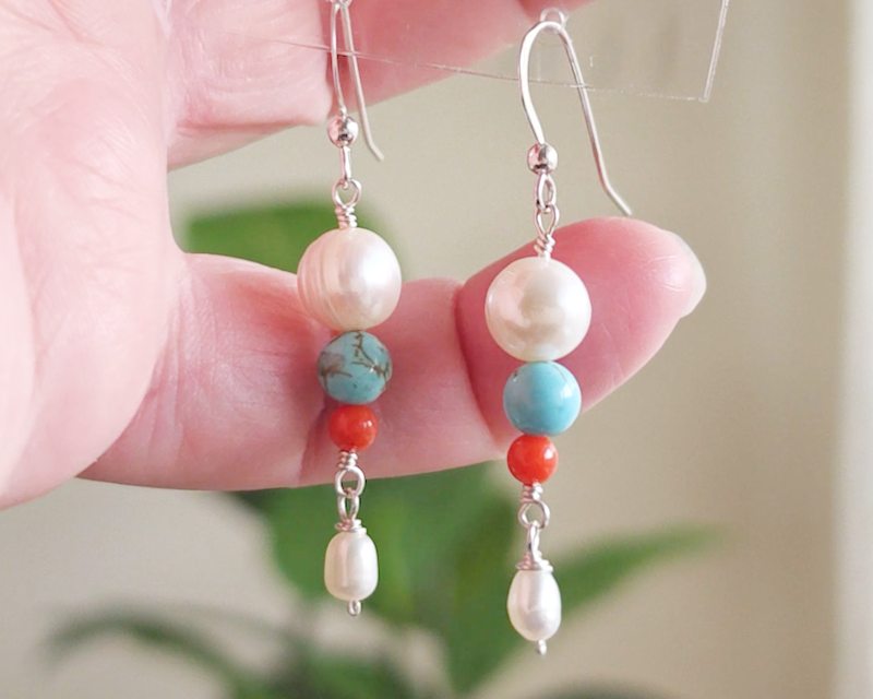 Long Turquoise Coral and Freshwater Cultured pearl dangle beaded earrings on silver french hooks in hand