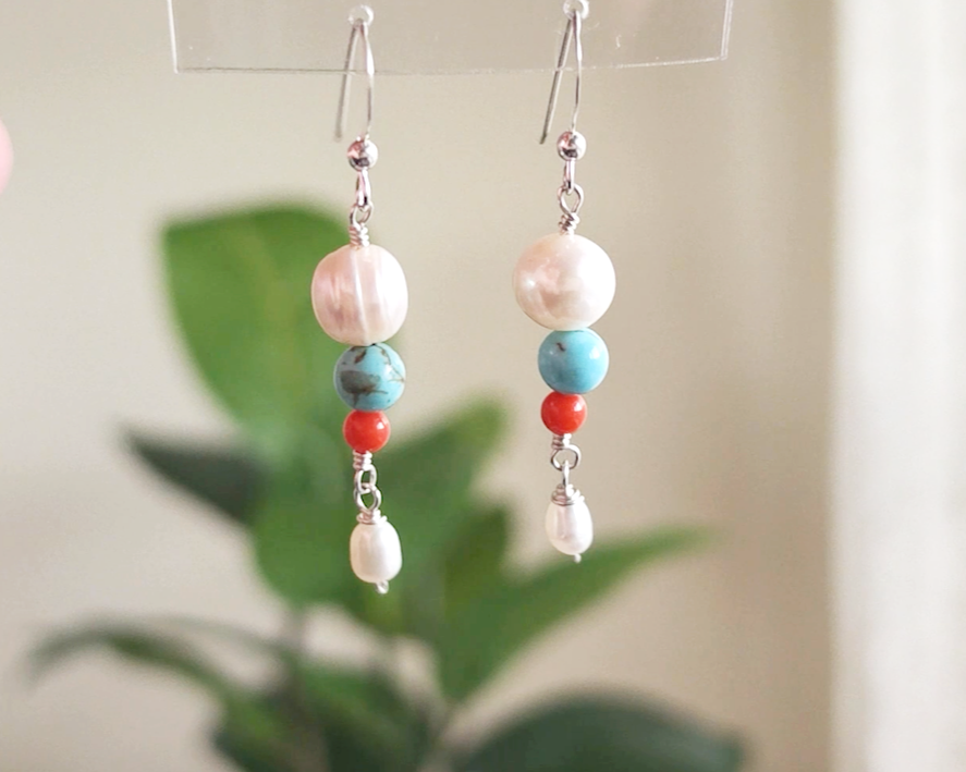 Long Turquoise Coral and Freshwater Cultured pearl dangle beaded earrings on silver french hooks with green background 