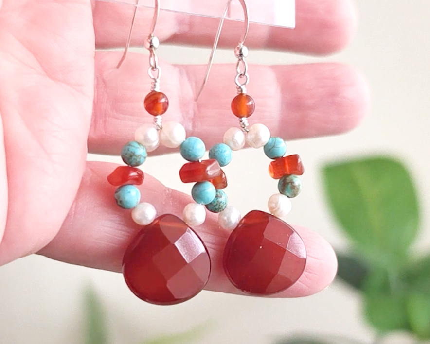 Handmade long dangle sterling silver Carnelian, Turquoise and Freshwater Cultured pearl earrings with large, faceted orange/brown Carnelian drop shape stones, vintage irregular Carnelian, Turquoise round and white pearls, in hand 