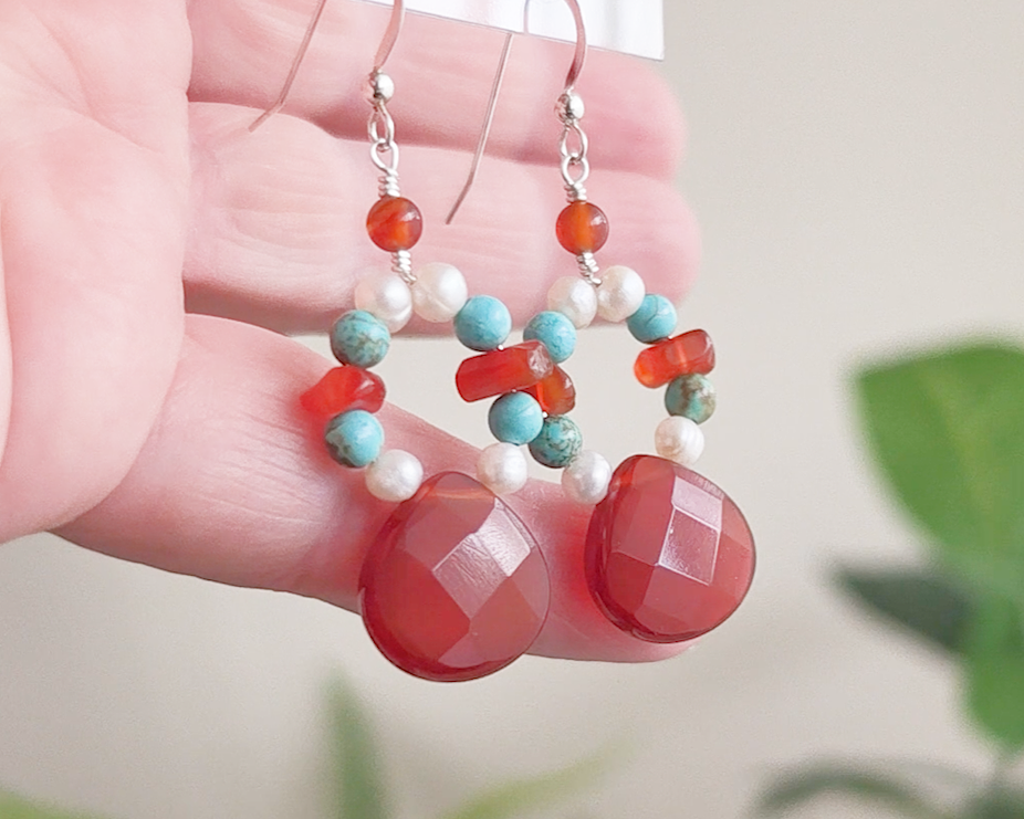 Handmade long dangle sterling silver Carnelian, Turquoise and Freshwater Cultured pearl earrings with large, faceted orange/brown Carnelian drop shape stones, vintage irregular Carnelian, Turquoise round and white pearls, in hand 