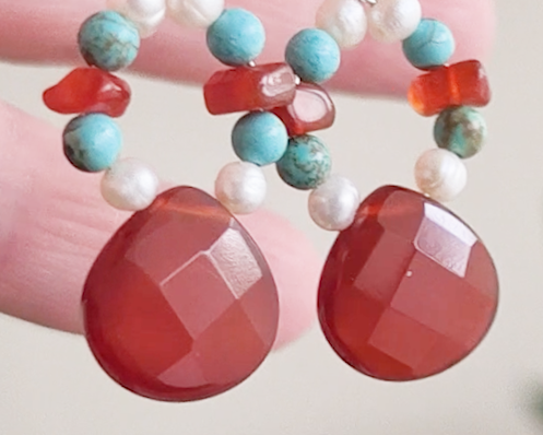Handmade long dangle sterling silver Carnelian, Turquoise and Freshwater Cultured pearl earrings with large, faceted orange/brown Carnelian drop shape stones, vintage irregular Carnelian, Turquoise round and white pearls, in hand 