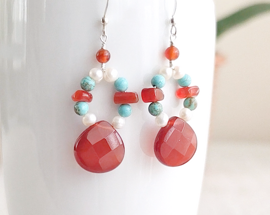 Handmade long dangle sterling silver Carnelian, Turquoise and Freshwater Cultured pearl earrings with large faceted orange/brown Carnelian drop shape stones, vintage irregular Carnelian, Turquoise round and white pearls, on white background 