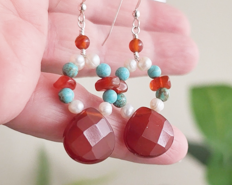 Handmade long dangle sterling silver Carnelian, Turquoise and Freshwater Cultured pearl earrings with large, faceted orange/brown Carnelian drop shape stones, vintage irregular Carnelian, Turquoise round and white pearls, in hand 