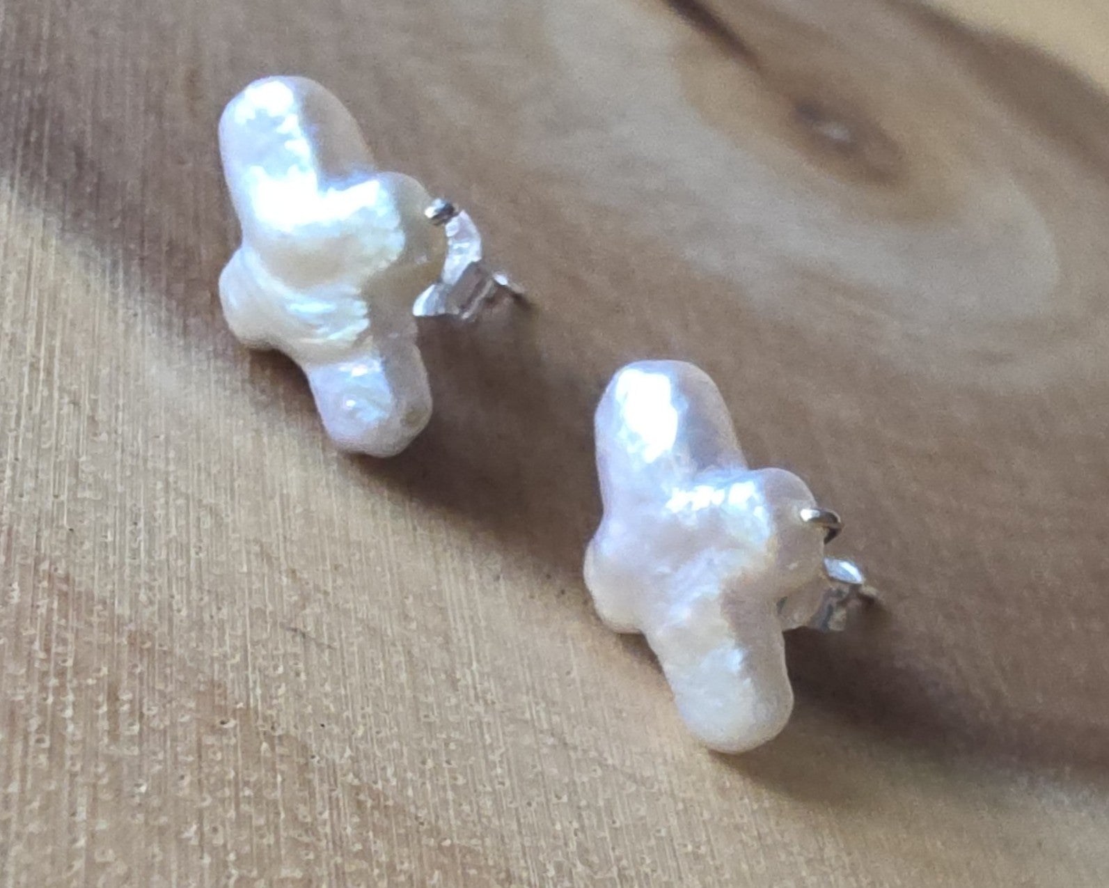 Sterling Silver Freshwater Cultured Peal Cross Stud Earrings with wood background.