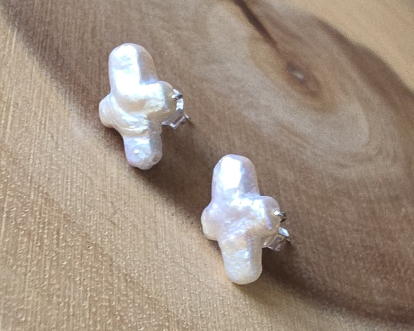Sterling Silver Freshwater Cultured Peal Cross Stud Earrings with wood background.