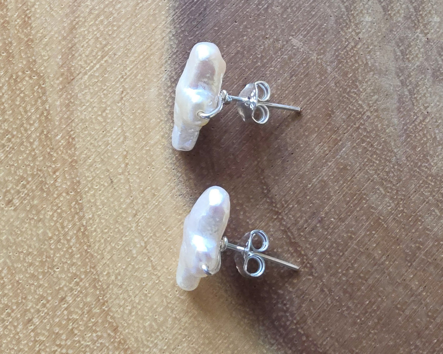 Sterling Silver Freshwater Cultured Peal Cross Stud Earrings with wood background.