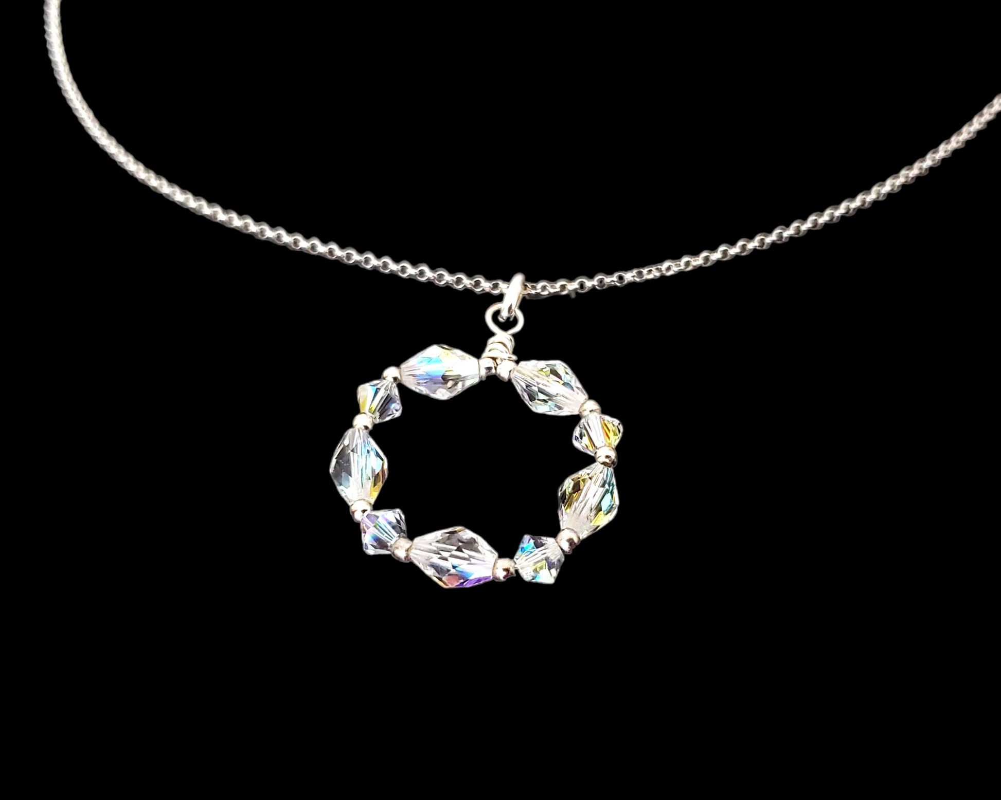 Sparkly Crystal Infinity Ring Circle Pendant on rolo chain, displayed on black background 