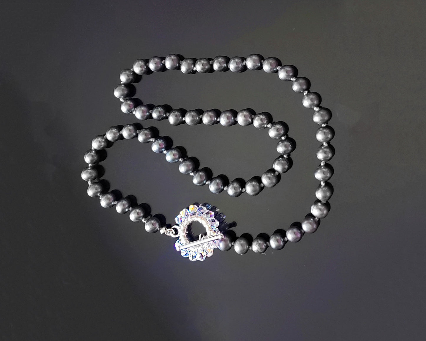 Celestial Brilliance Grey Freshwater Cultured Pearl Necklace, Hand knotted featuring a fabulous crystal starburst design toggle clasp. 