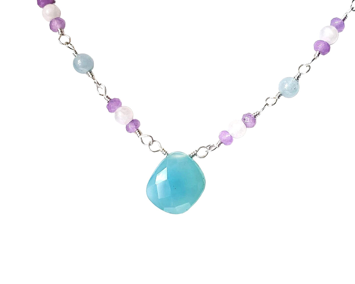 Handmade Blue, Lavender and white Blue Chalcedony, Moonstone, Aquamarine, Lavender Quartz, Sterling Silver wire wrapped necklace with large blue stone in with white background 
