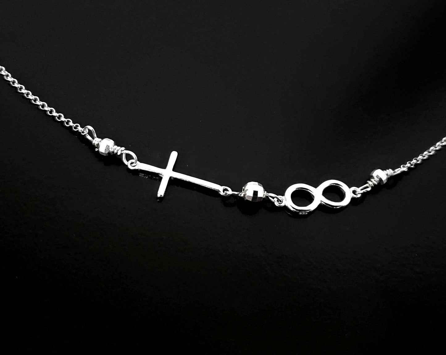 Infinite Faith Sideways Cross Infinity Necklace with an Infinity Pendant and Cross attached to chain with sparkly beads. 