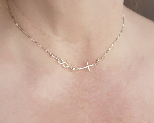 Sterling Silver Sideways Necklace with sideways Cross and Infinity symbol pendant on chain with sparkly silver beads on neck.