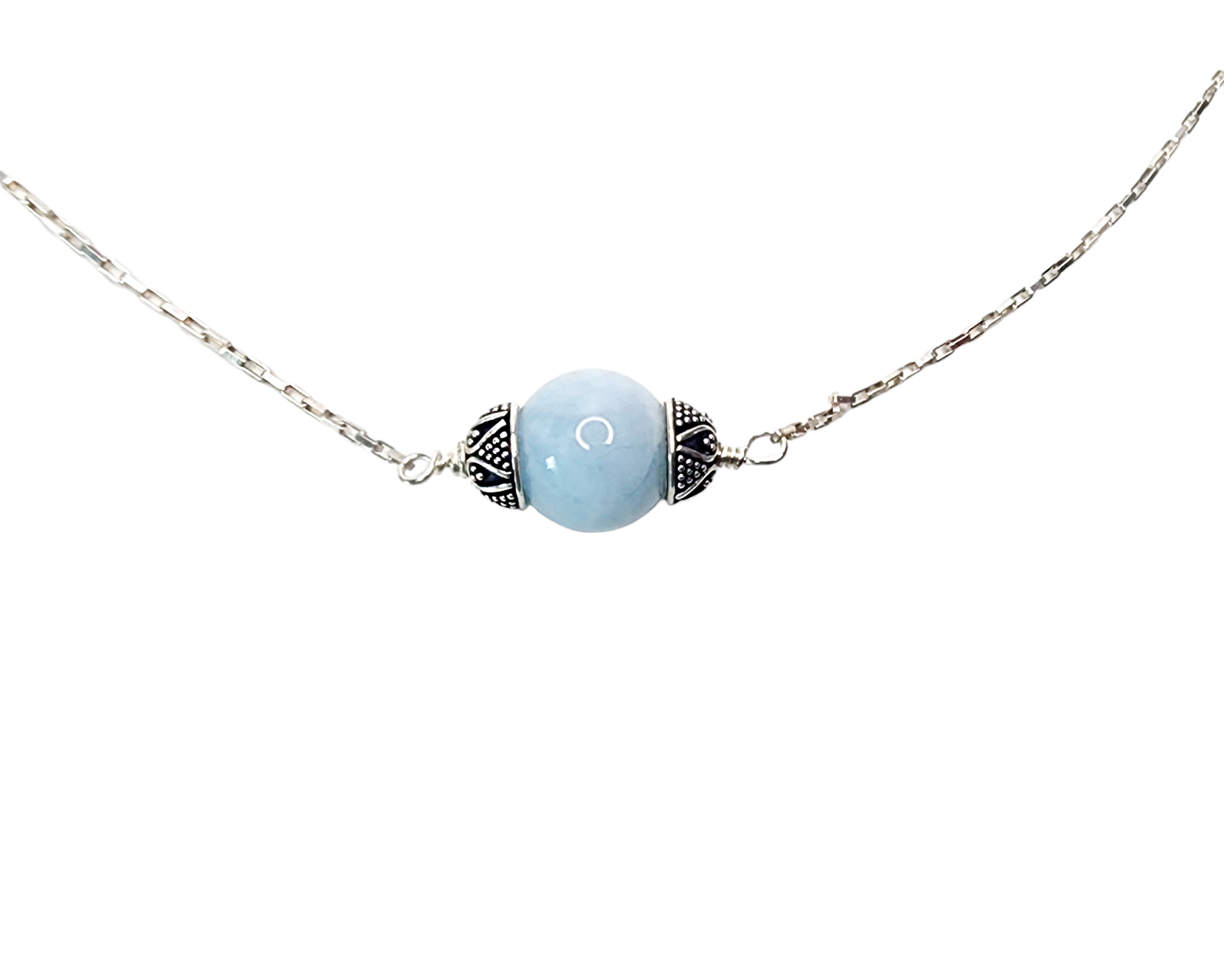 Aquamarine Necklace with one large single round polished Aquamarine stone, a floating Aquamarine accented on either side with decorative, antiqued Sterling Silver caps in centre of Sterling Silver wired to sleek shinny elongated box chain.