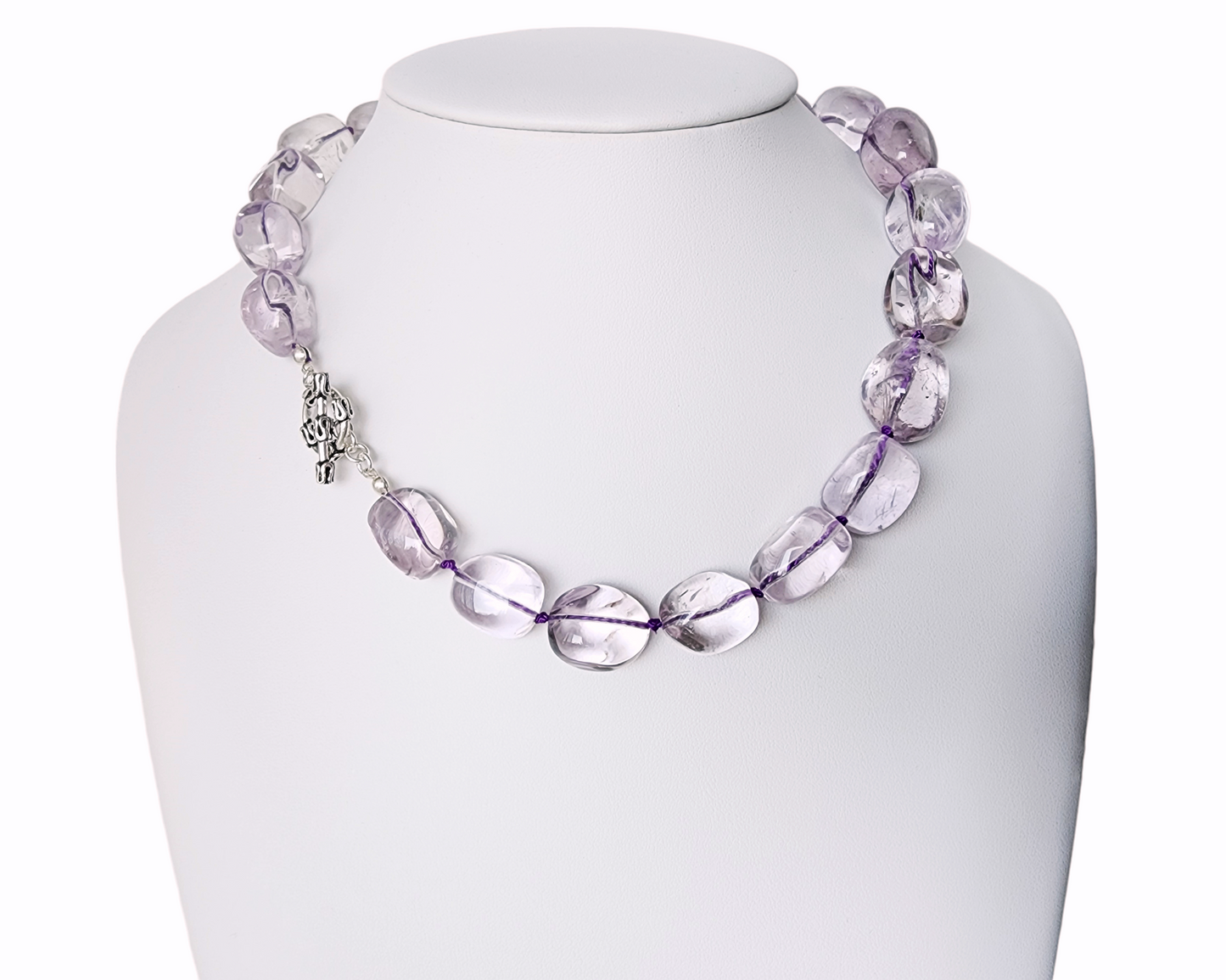 Translucent lavender Amethyst Nugget necklace, hand knotted with genuine Silk cord, finished with Sterling Silver and fancy antiqued Toggle Clasp on white display 