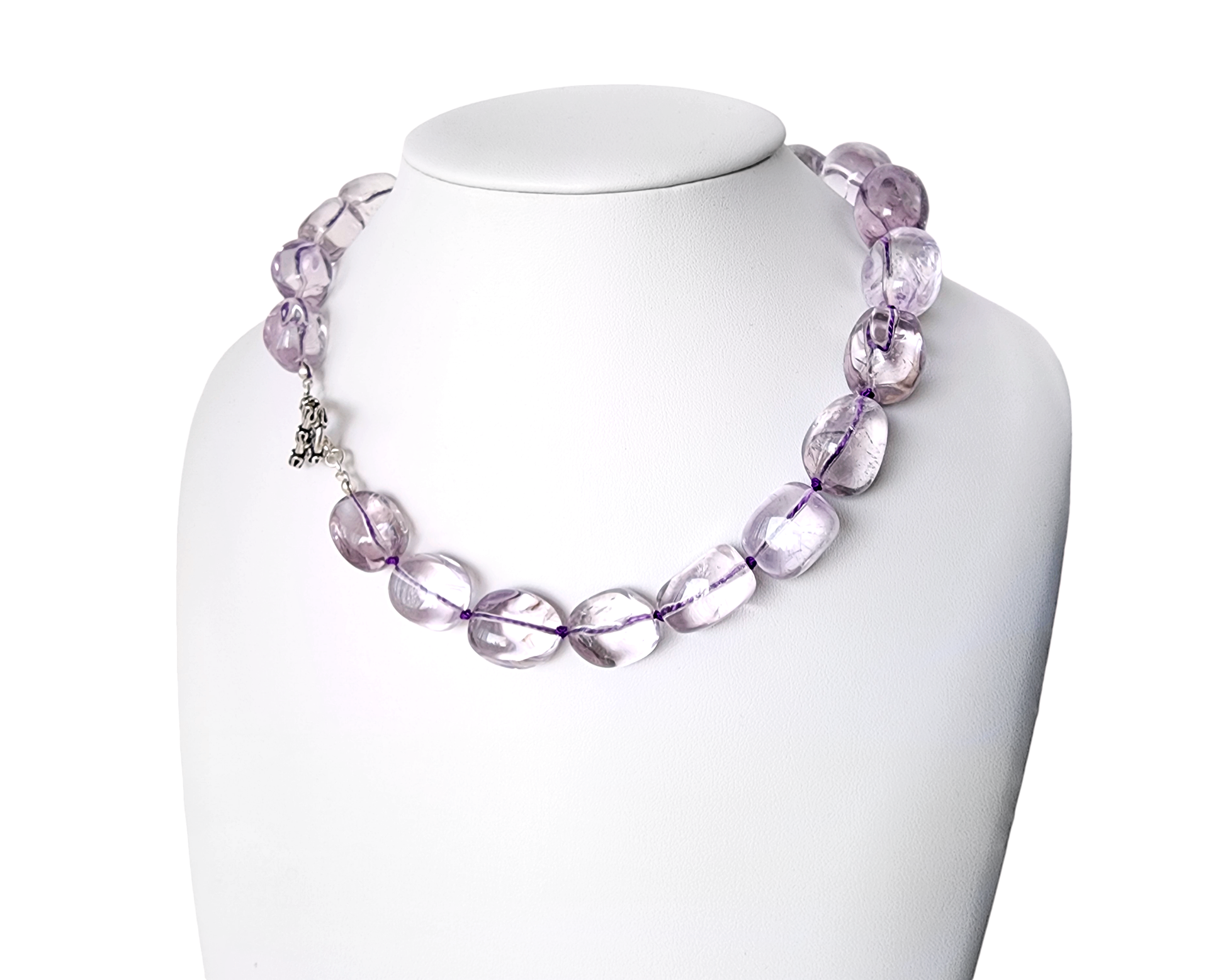 Translucent lavender Amethyst Nugget necklace, hand knotted with genuine Silk cord, finished with Sterling Silver and fancy antiqued Toggle Clasp on white display 