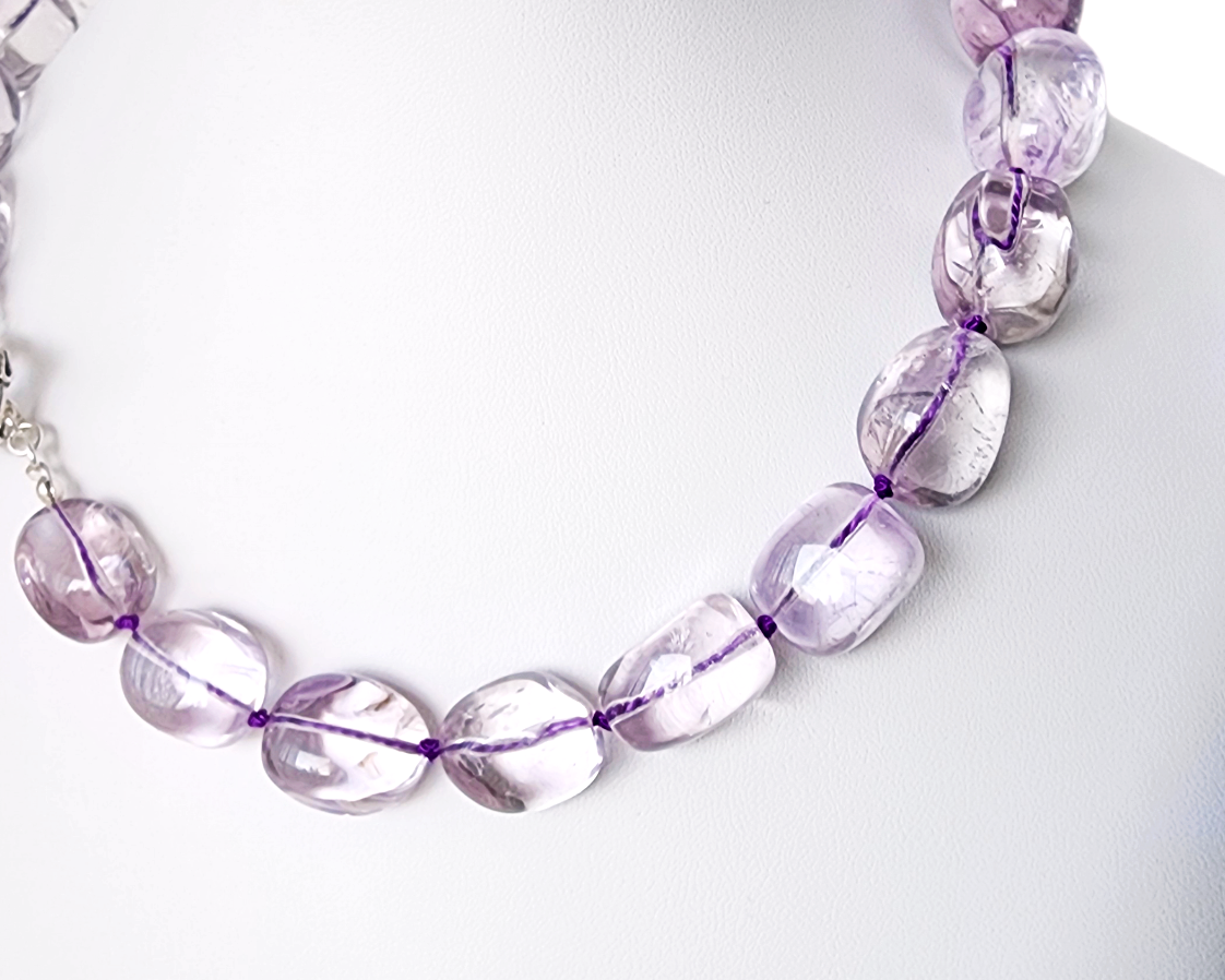 Translucent lavender Amethyst Nugget necklace, hand knotted with genuine Silk cord, finished with Sterling Silver and fancy antiqued Toggle Clasp on white display 