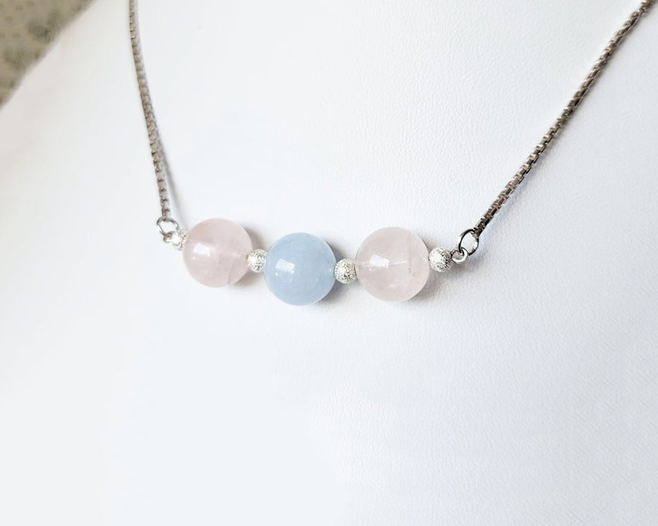 Three Gemstone Necklace with two Rose Quartz on either side of an Aquamarine in the center box link Sterling Silver chain and extension chain. 