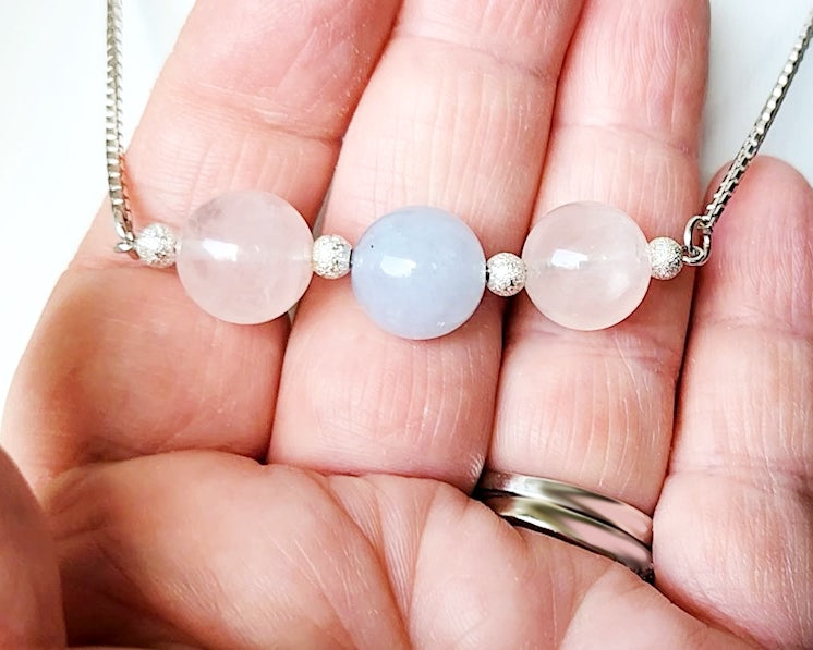 Three Gemstone Necklace with two Rose Quartz on either side of an Aquamarine in the center box link Sterling Silver chain and extension chain. 