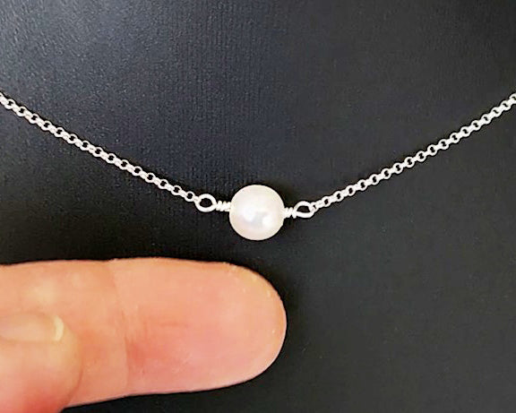 Floating Freshwater Cultured Pearl Necklace with a single white pearl in the centre of the Sterling Silver rolo style chain. 