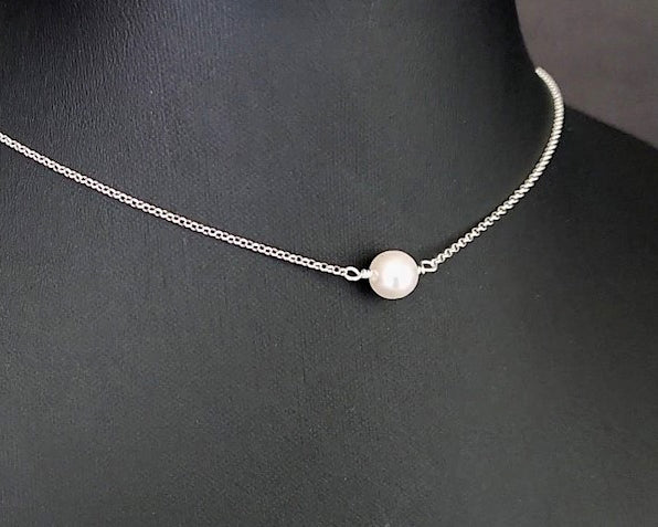 Floating Freshwater Cultured Pearl Necklace with a single white pearl in the centre of the Sterling Silver rolo style chain. 