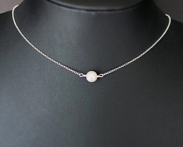 Floating Freshwater Cultured Pearl Necklace with a single white pearl in the centre of the Sterling Silver rolo style chain. 