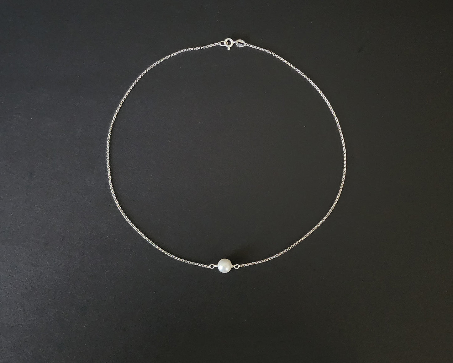 Floating Freshwater Cultured Pearl Necklace with a single white pearl in the centre of the Sterling Silver rolo style chain. 