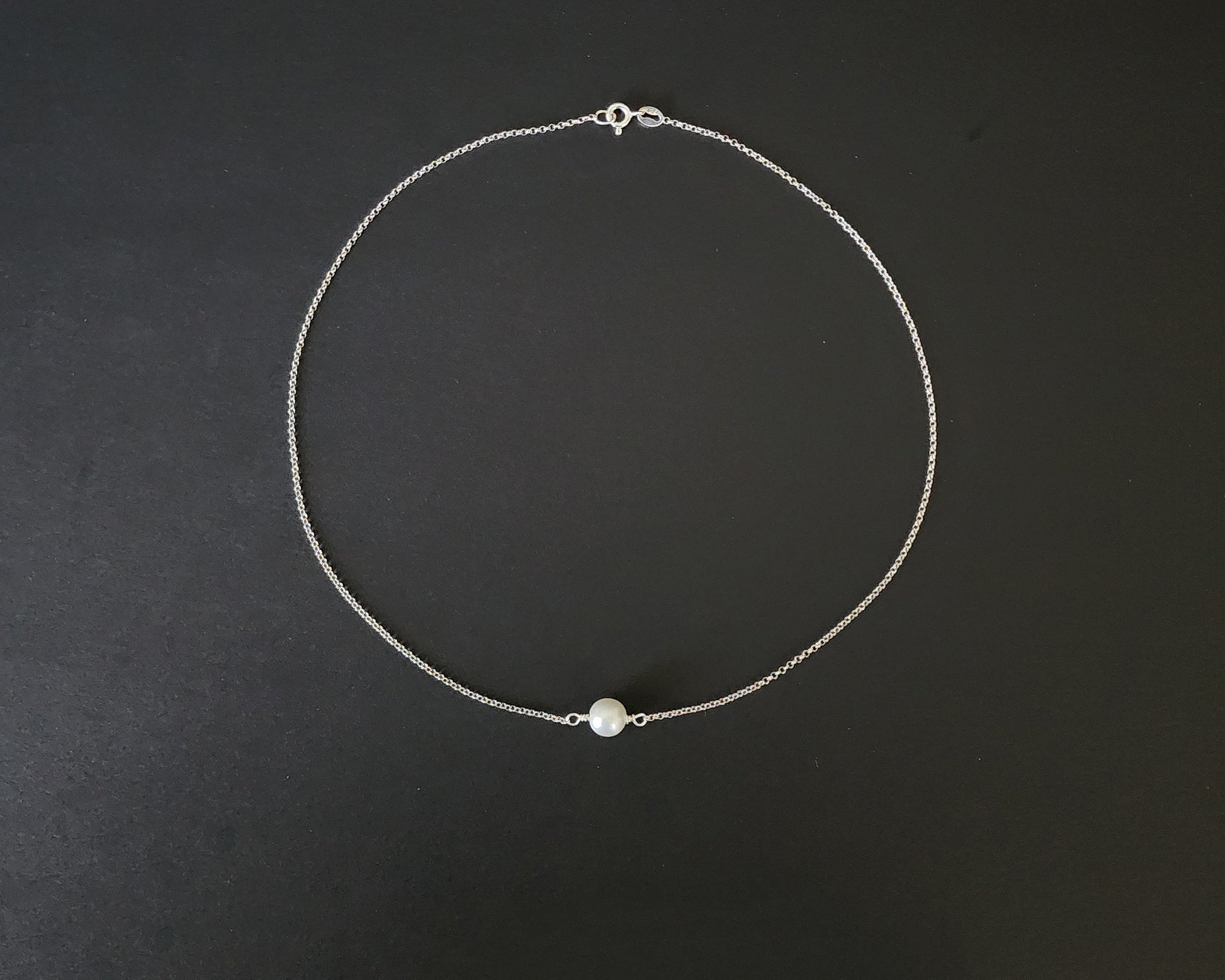 Floating Freshwater Cultured Pearl Necklace with a single white pearl in the centre of the Sterling Silver rolo style chain. 