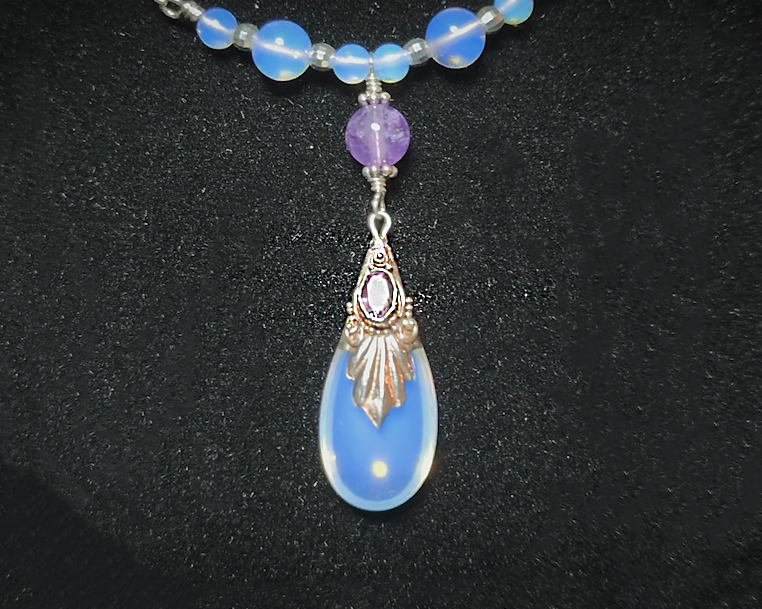 Sterling Silver Art Deco Style Opalite Amethyst Necklace with large drop shape synthetic opal, faceted Amethyst dangling from round Amethyst and Opalite beads and Chain on black background 