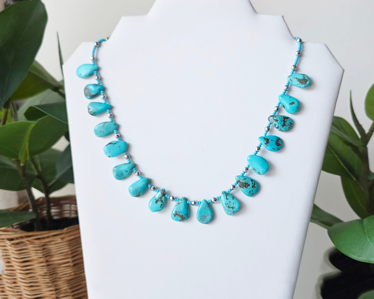 Turquoise Beaded Collar Necklace with blue Turquoise Drop Shaped Stones, sparkly silver Hematite beads and tiny glass seed beads, on white display and background 
