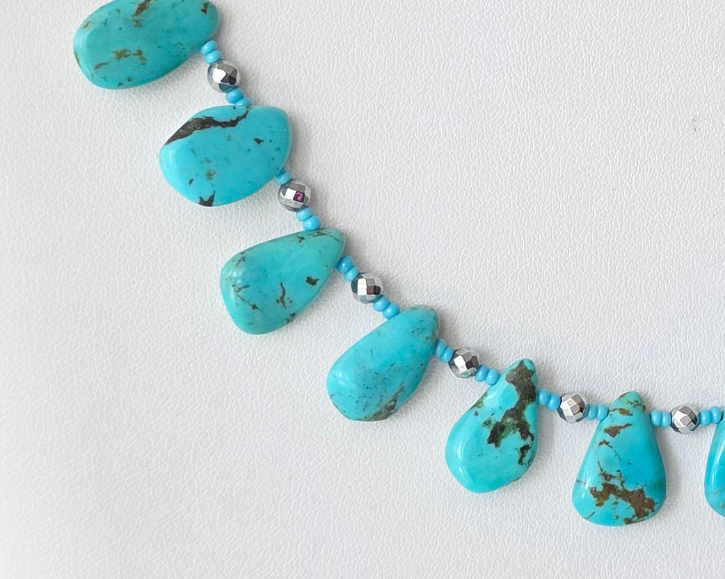 Turquoise Beaded Collar Necklace with blue Turquoise Drop Shaped Stones, sparkly silver Hematite beads and tiny glass seed beads, on white display and background 