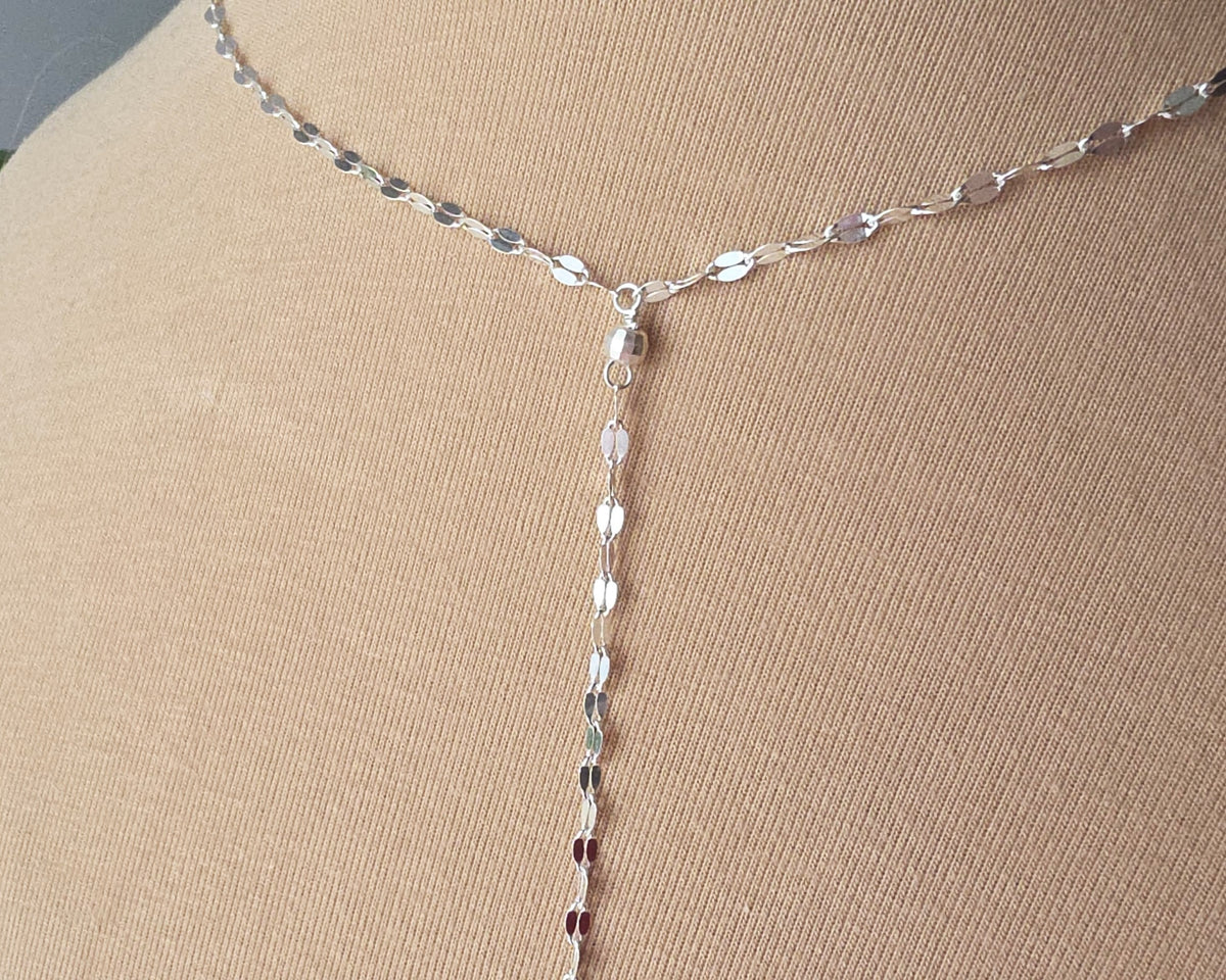 Sparkly Sterling Silver Decorative Chain Lariat necklace with brilliant flat decorative chain, sparkly faceted beads on beige background