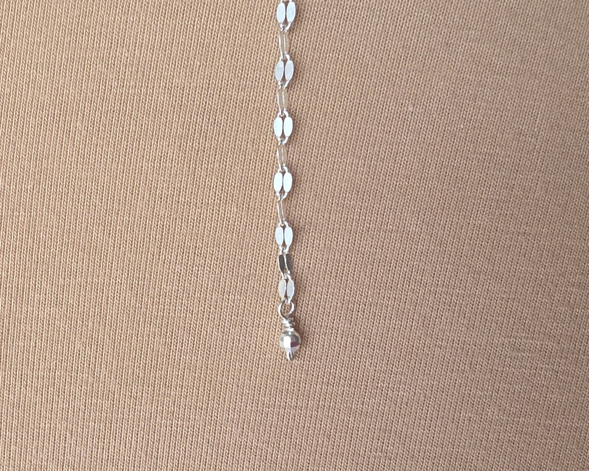 Sparkly Sterling Silver Decorative Chain Lariat necklace with brilliant flat decorative chain, sparkly faceted beads on beige background