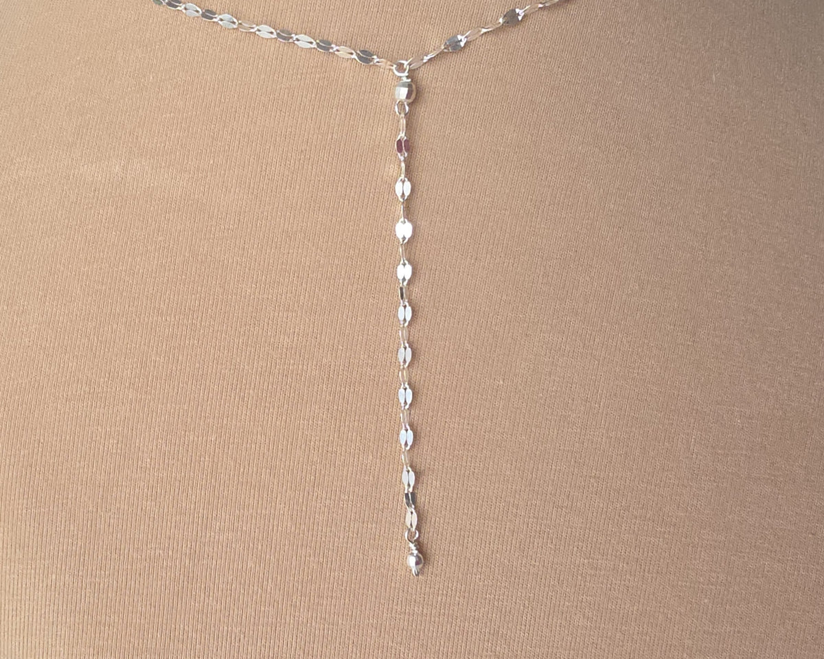 Sparkly Sterling Silver Decorative Chain Lariat necklace with brilliant flat decorative chain, sparkly faceted beads on beige background
