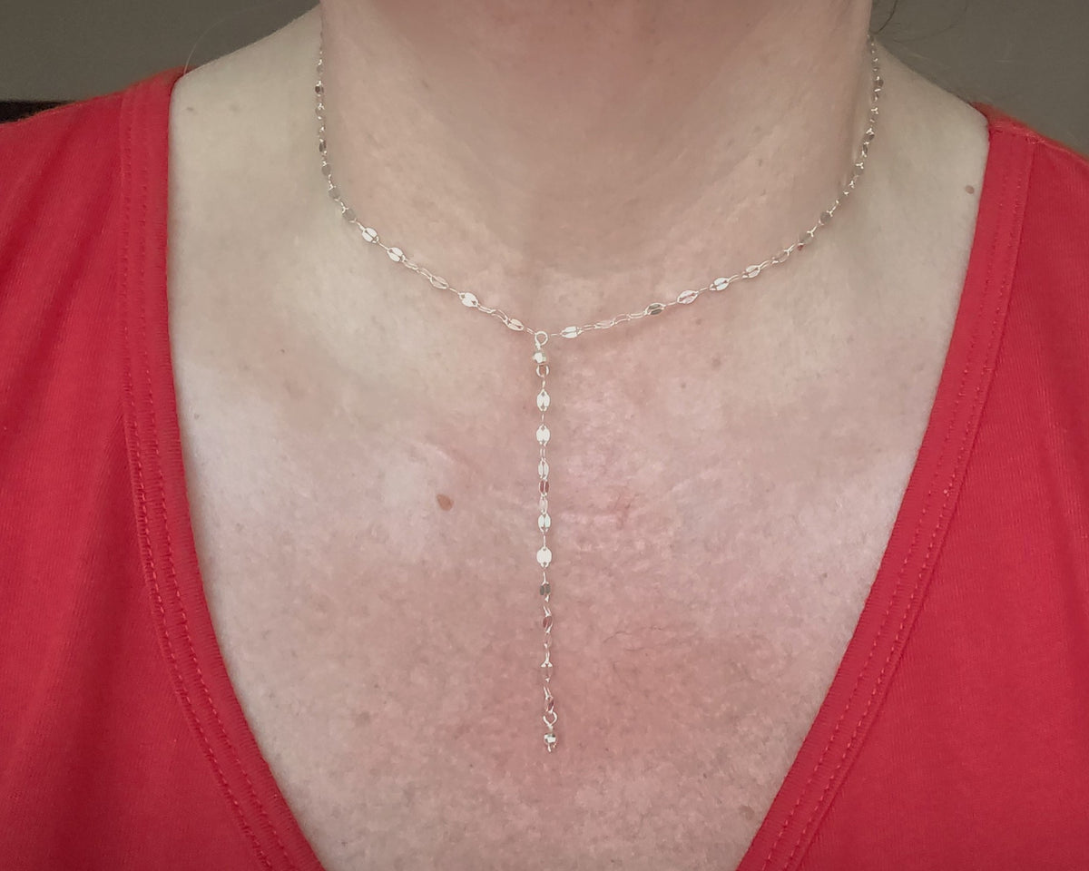 Sparkly Sterling Silver Decorative Chain Lariat necklace with brilliant flat decorative chain, sparkly faceted beads on neck with red shirt