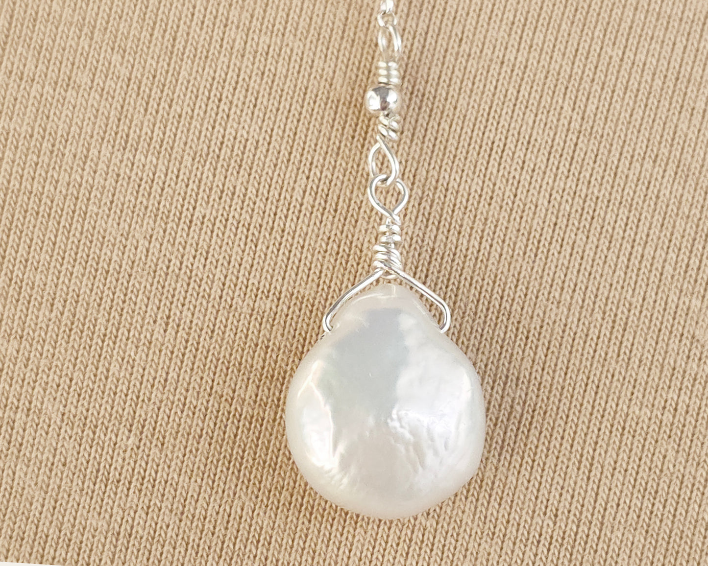 Lage white coin drop shape pearl on silver 