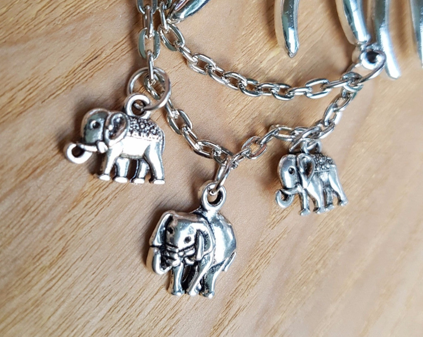 Silver tone Elephant Family Necklace, two adult elephants with baby elephants dangling below with siler chain.  