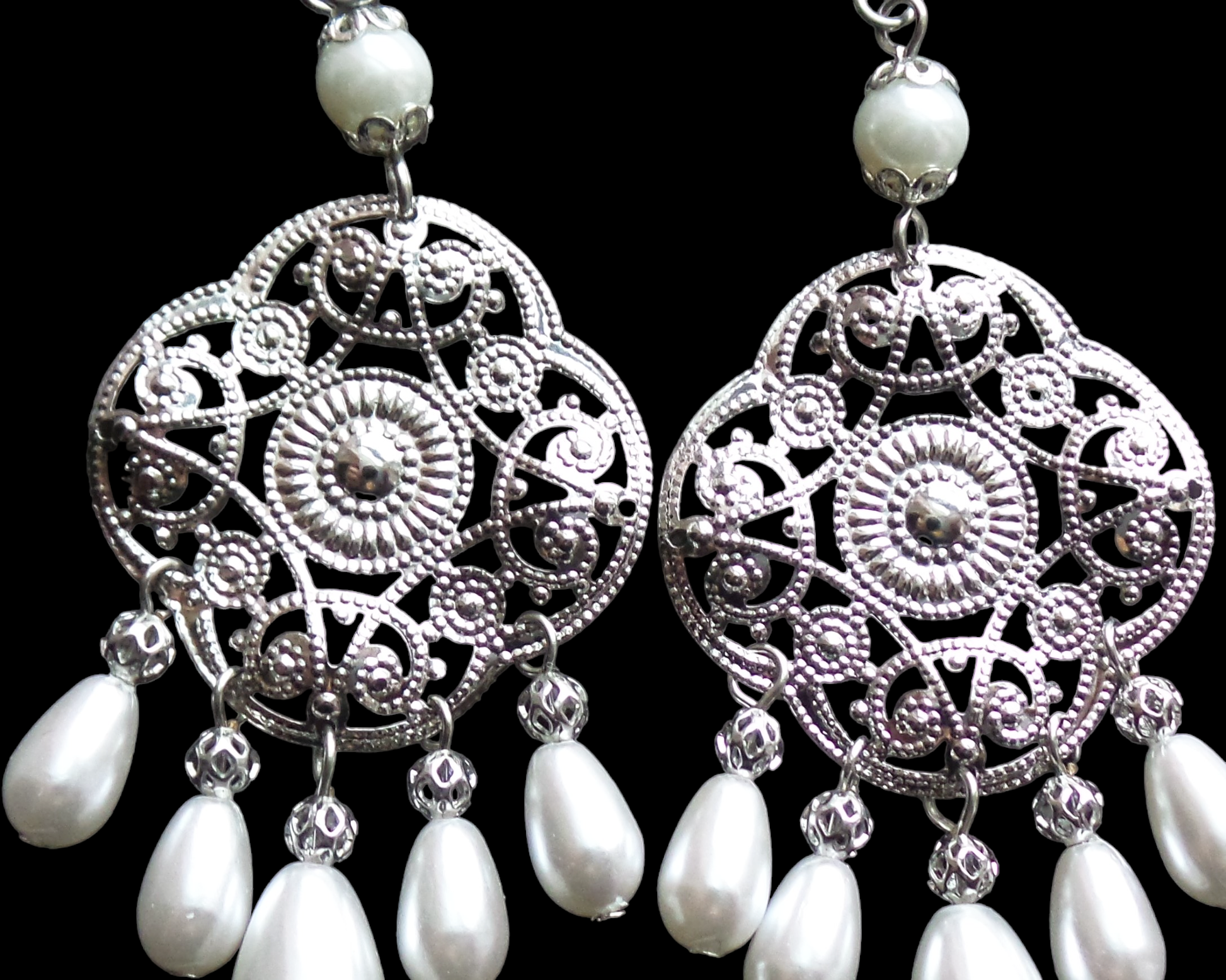 Extra Long Art Deco Style Pearl Chandelier Earrings with silver tone, white gold color metal and white drop shaped pearls, displayed on black background