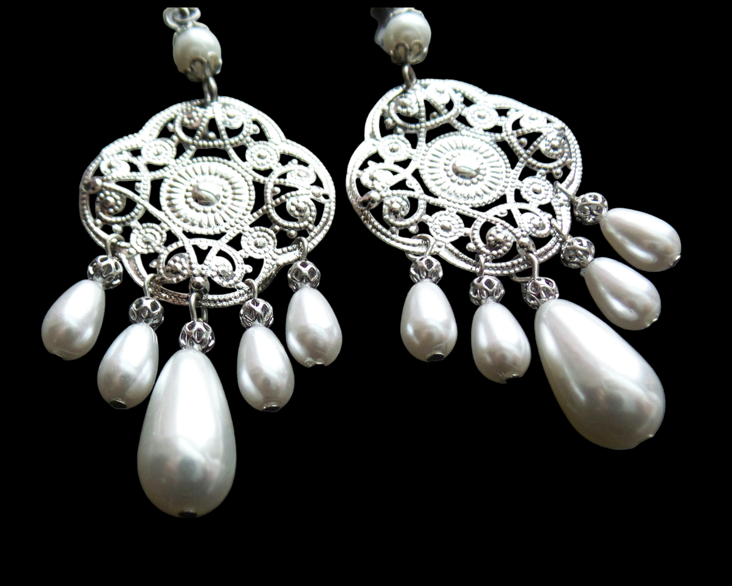 Extra Long Art Deco Style Pearl Chandelier Earrings with silver tone, white gold color metal and white drop shaped pearls, displayed on black background