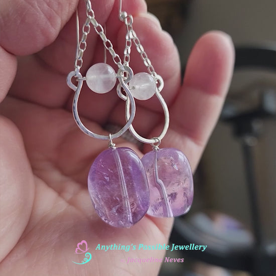 Video of Long Handmade Amethyst Nugget Rose Quartz Dangle Chandelier Earrings with translucent lavender Amethyst and pale pink Rose Quartz and french earrings hooks displayed in a hand 