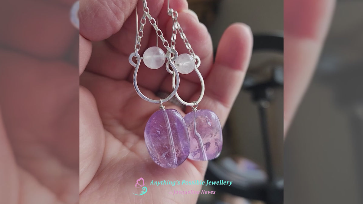 Video of Long Handmade Amethyst Nugget Rose Quartz Dangle Chandelier Earrings with translucent lavender Amethyst and pale pink Rose Quartz and french earrings hooks displayed in a hand 