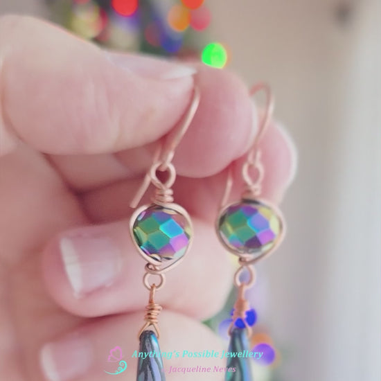 Video of Long handmade dragonfly wing crystal earrings with blue multi color crystal beads wire wrapped with copper in hand