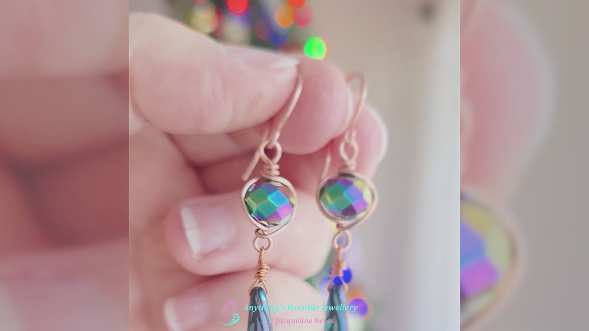 Video of Long handmade dragonfly wing crystal earrings with blue multi color crystal beads wire wrapped with copper in hand