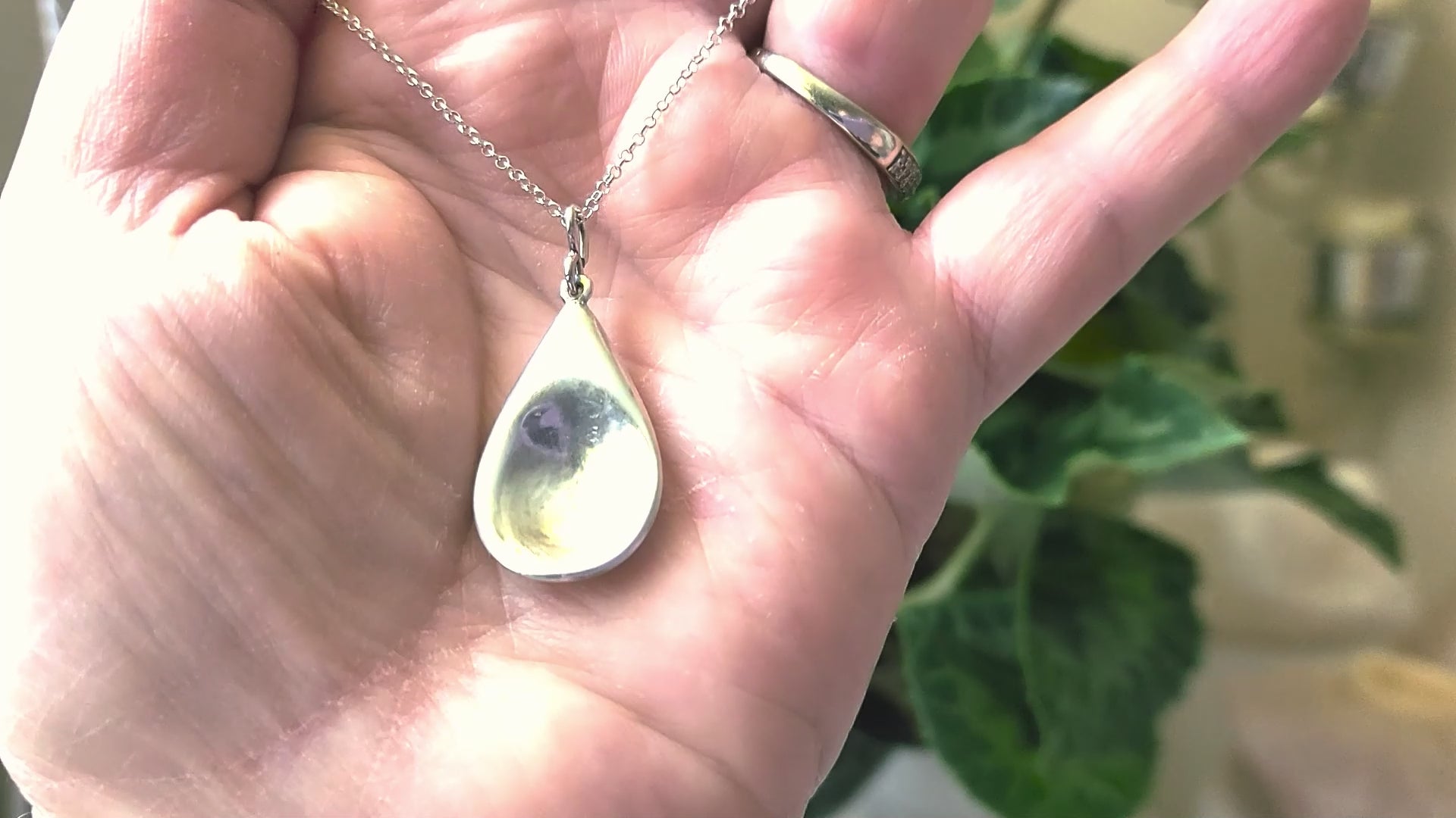 Video of Love inspired spoon shaped Sterling Silver pendant on rolo style chain 