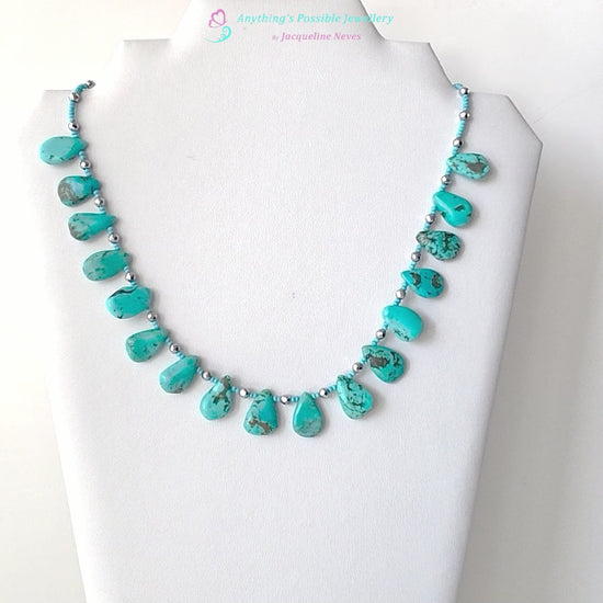 Turquoise Beaded Collar Necklace with blue Turquoise Drop Shaped Stones, sparkly silver Hematite beads and tiny glass seed beads, on white display and background 