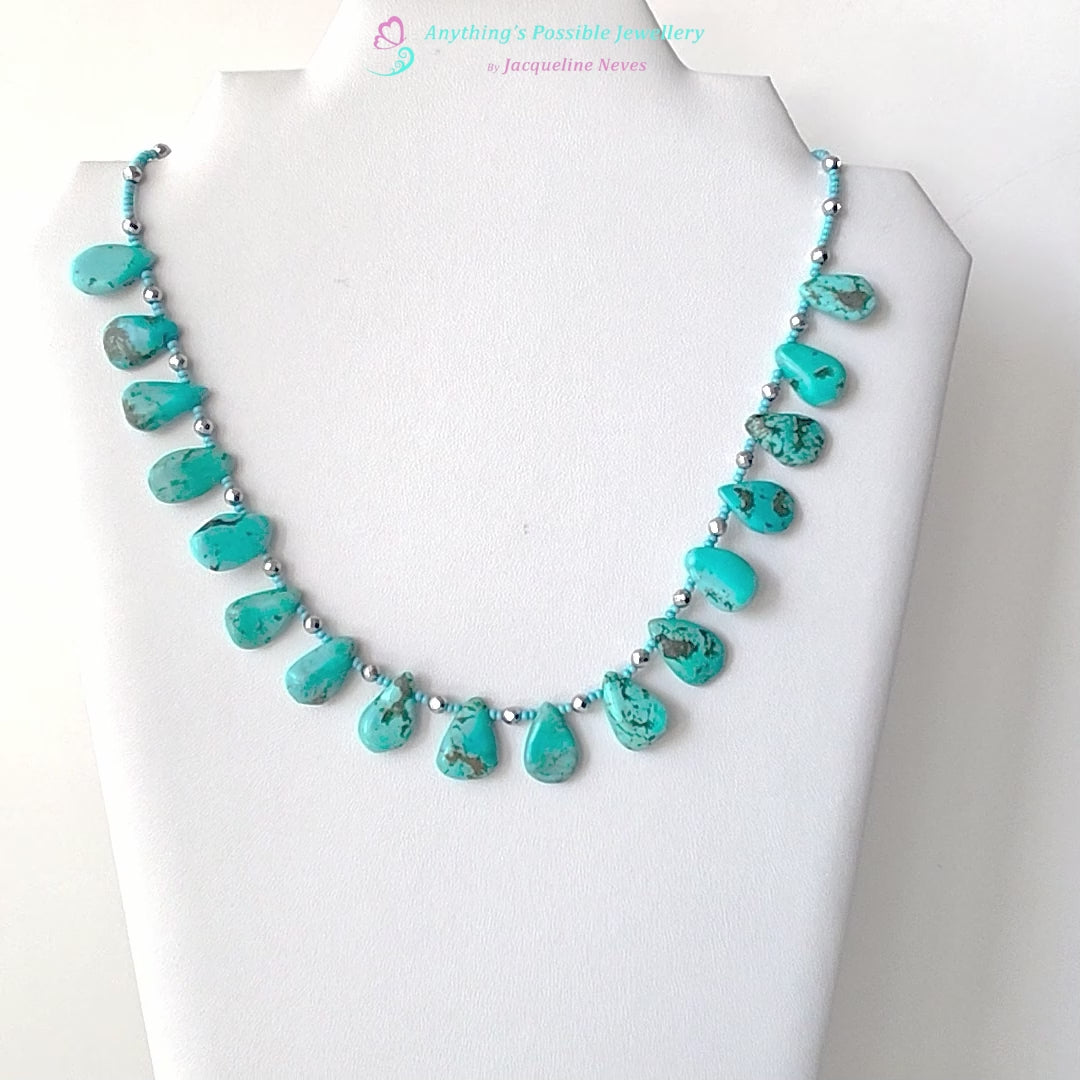 Turquoise Beaded Collar Necklace with blue Turquoise Drop Shaped Stones, sparkly silver Hematite beads and tiny glass seed beads, on white display and background 